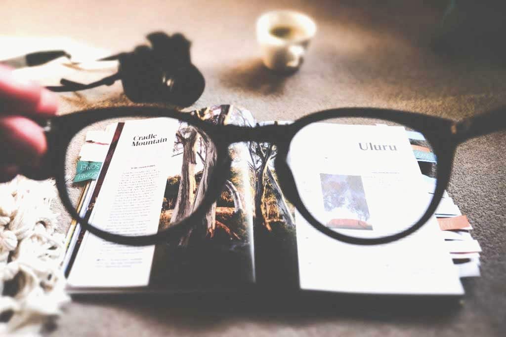 Proofreading a magazine through reading glasses